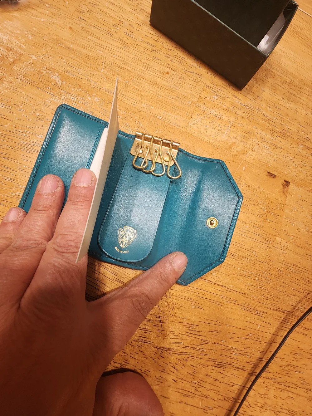 vintage Gucci teal leather key case featuring a distinctive cabochon stone